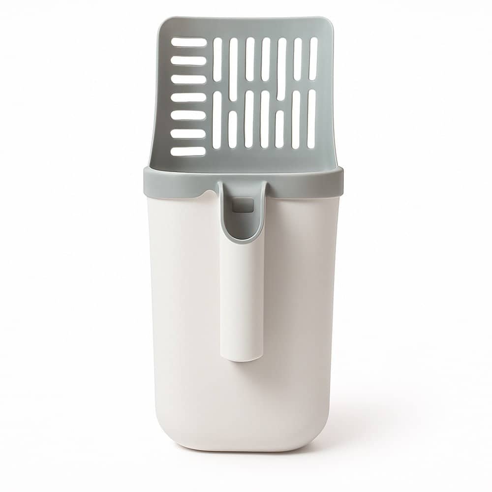 cat litter scoop with built-in bin resting on wooden floor